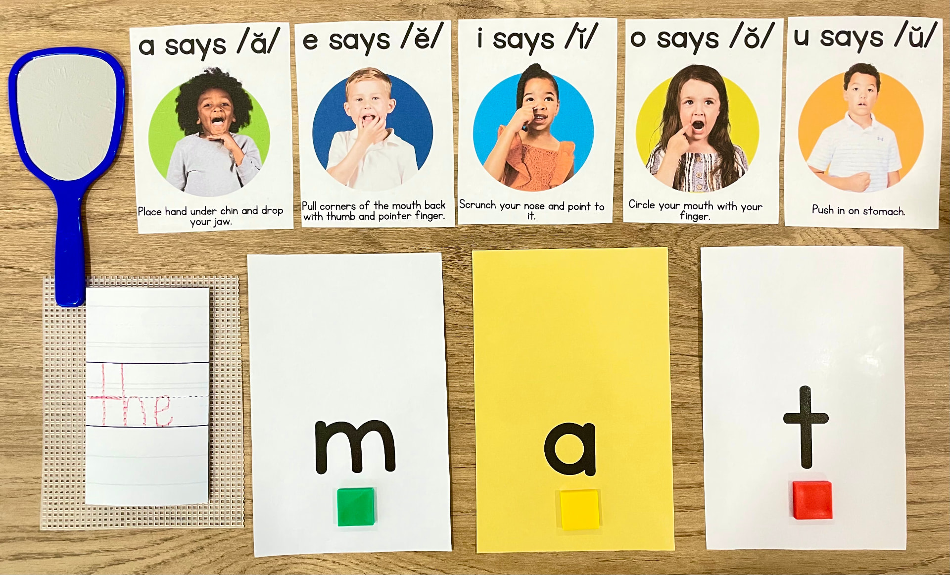 Beginner Orton-Gillingham materials with vowel articulation cards, a mirror, handwriting practice, and letter tiles